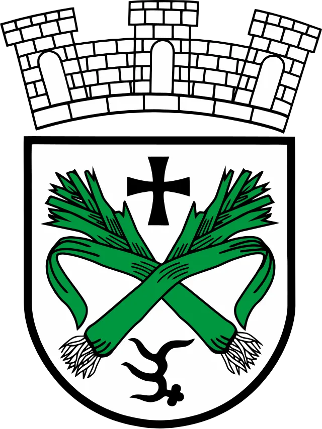 Wappen von Lauchheim - Das Wappen zeigt eine Zinnenkrone, symbolisch für die Stadtrechte, und zwei grüne Garben, die die landwirtschaftliche Tradition der Stadt repräsentieren.